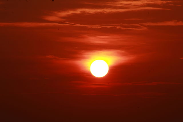 beautiful sunseti view , moon in lap of sky . golden view of moon on the Sky