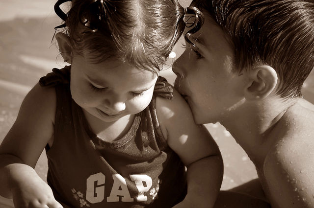 Big brother giving his little sis a sweet kiss!