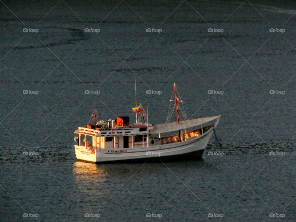 fishing boat in a calm bay