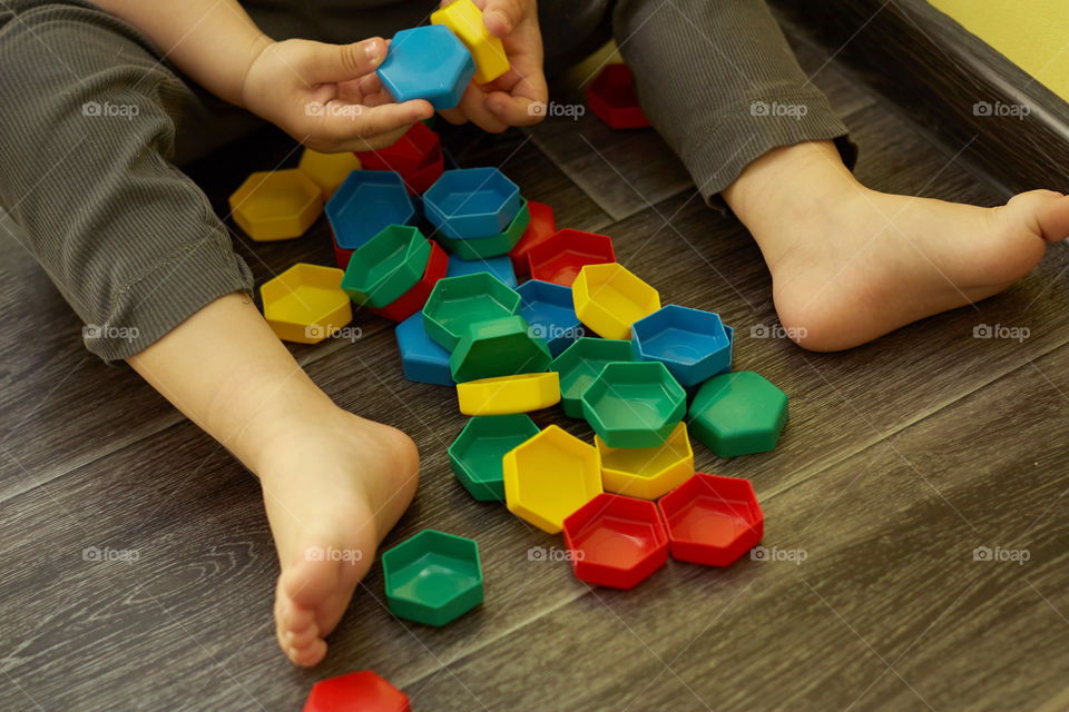 a child plays a colorful mosaic