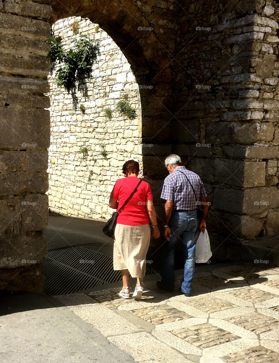 Two people walking the streets of Sicily 