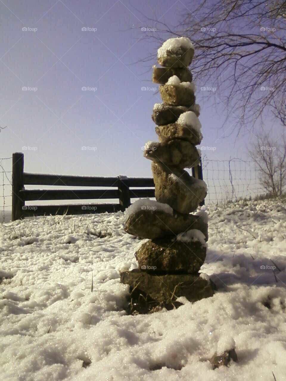 rock cairn on hillside. I added one each day on my walks until it fell over