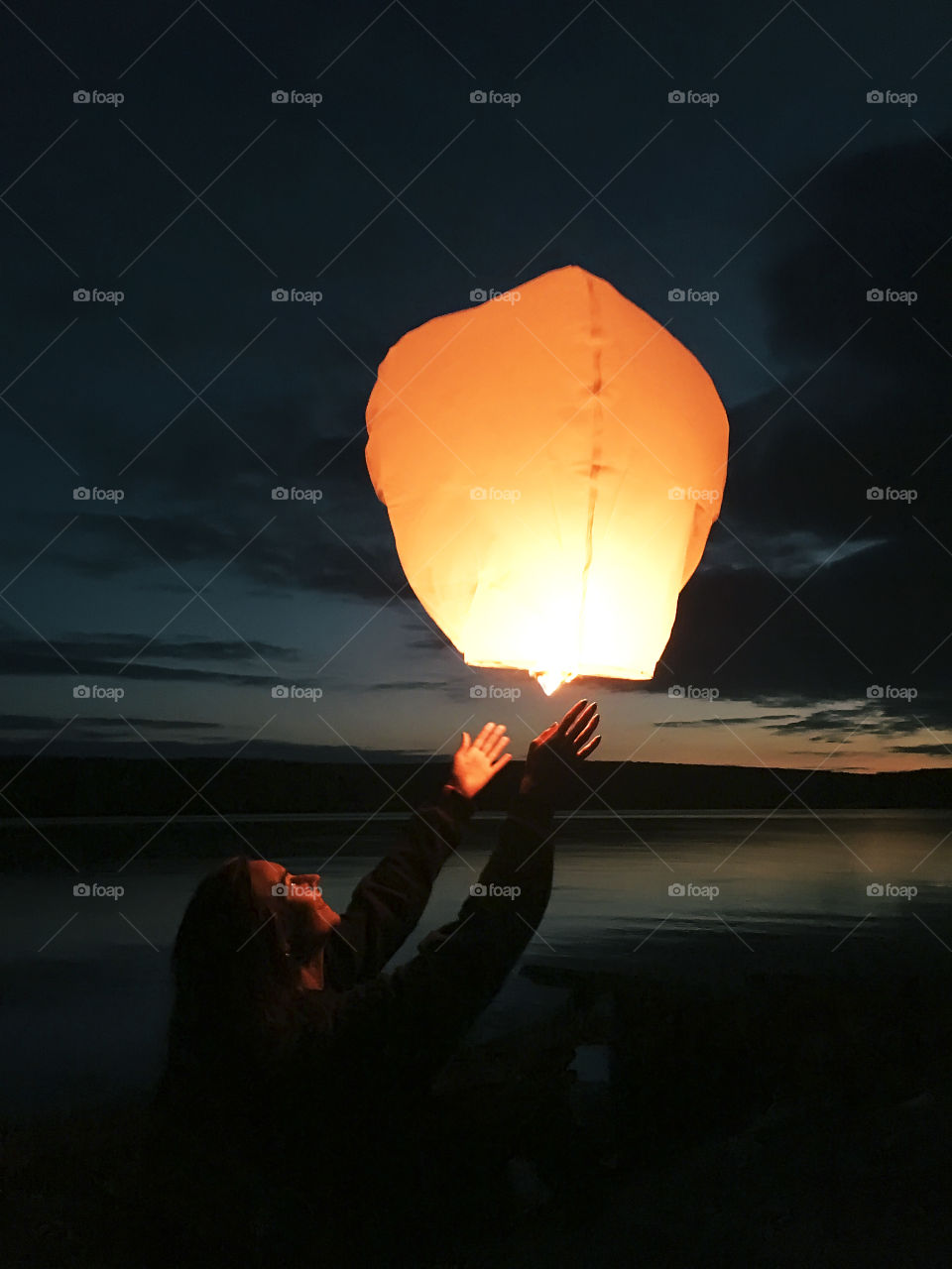 Making a wish under the Chinese lantern at night 