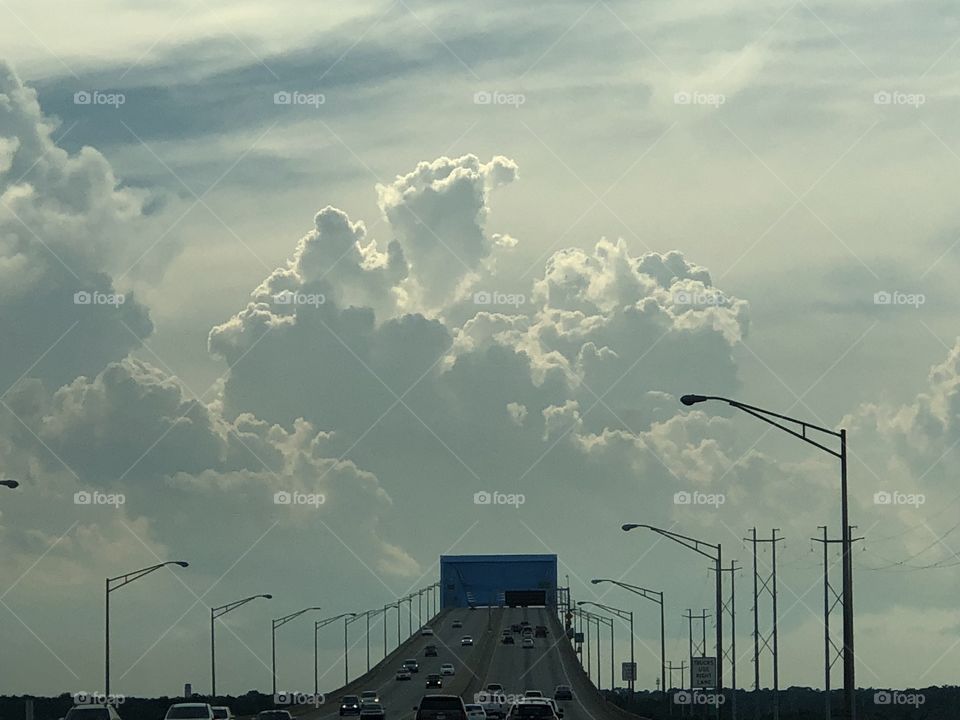 Epic cloud formation towering over a bridge