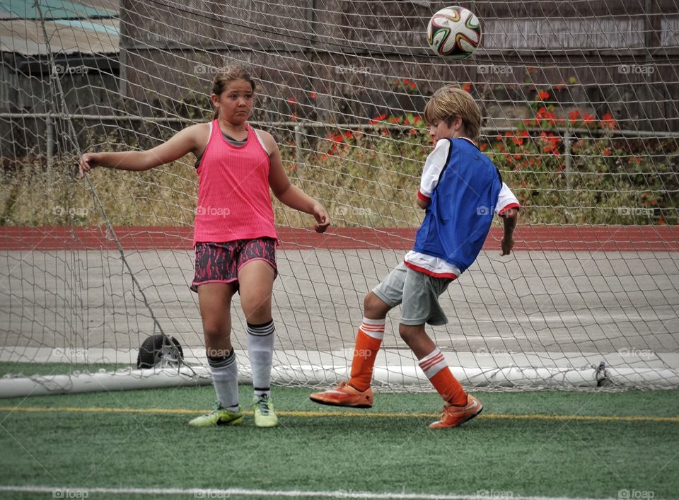 Youth Soccer. Boy And Girl Playing Soccer
