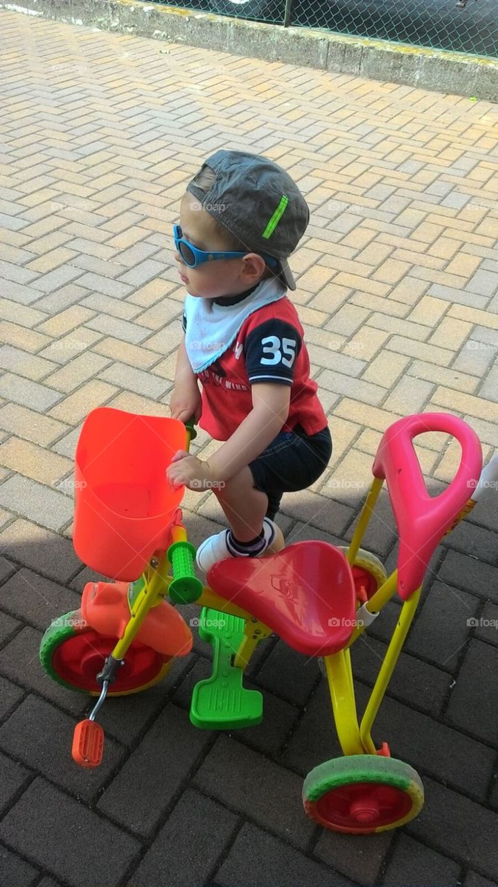 Elevated view of boy with tricycle in park