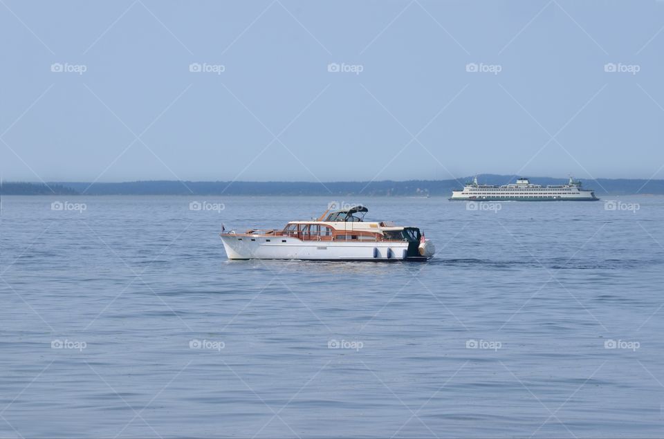 A yacht  sits idly by in the Puget sound of West Seattle, Washington.