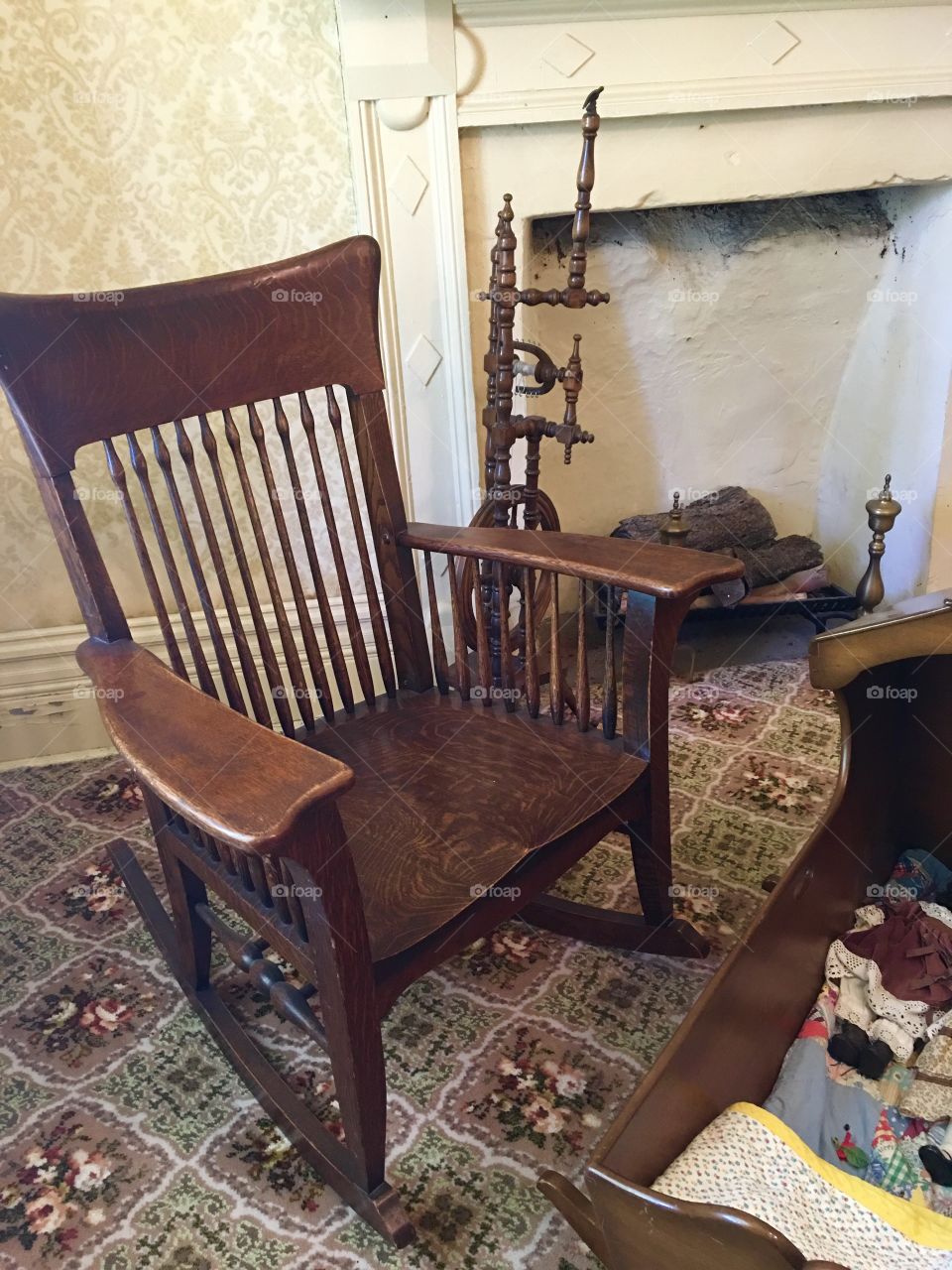 Old wooden rocking chair. Hand crafted. Traditional. Antique. Fireplace. 