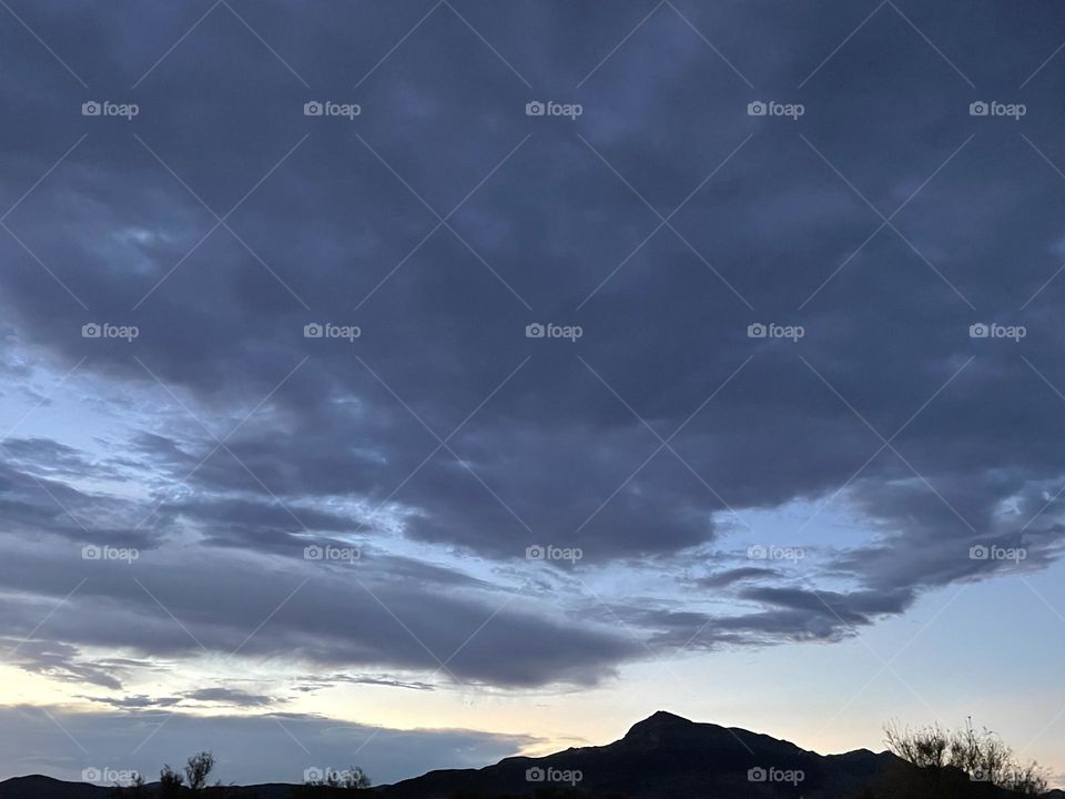 A sunset with mountains and clouds.