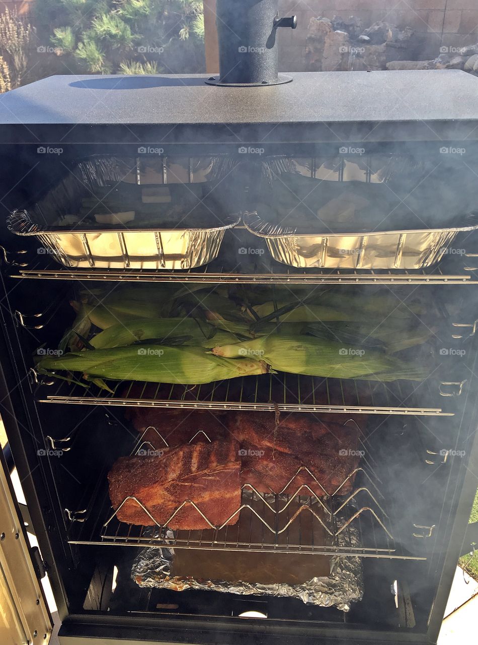 Ribs and corn on the cob in the smoker. 