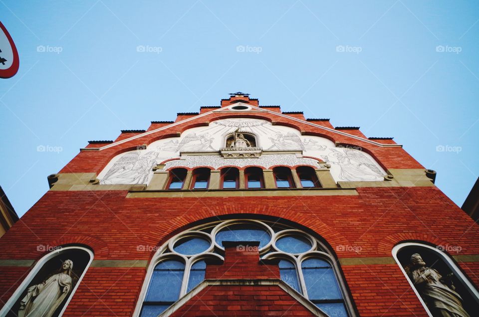 Low angle view of church exterior against sky in Kraków, Poland.