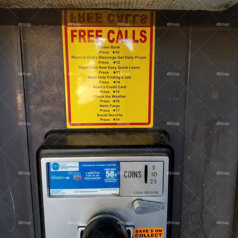 Pay phone with strange sign