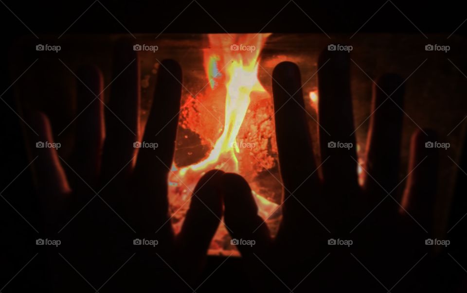 Hands in front fire.