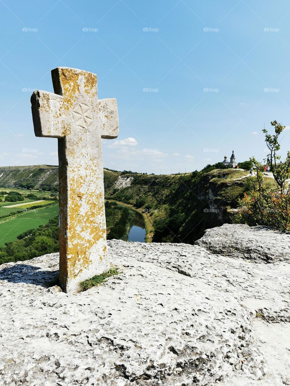 Ancient Christian stone cross above the valley in the Old Orhei, Moldova