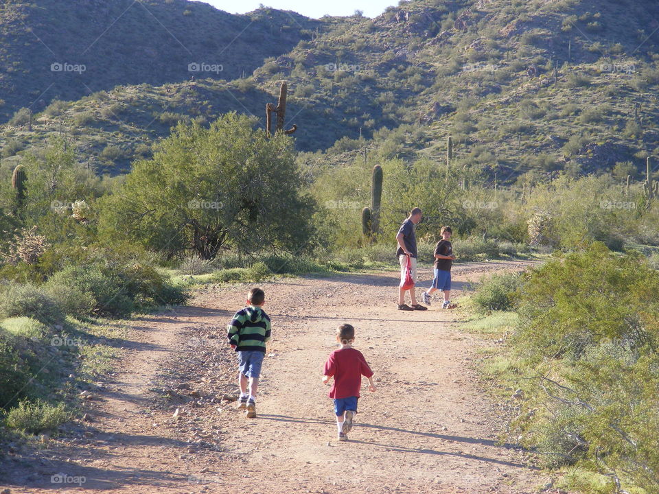 People hiking a trail in the Arizona desert