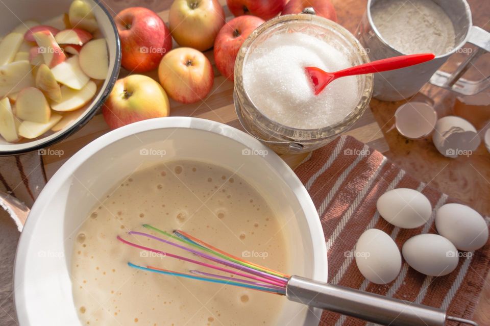 Making homemade puffed apple pie with eggs, sugar and flour.