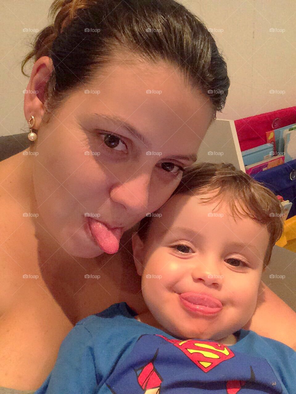 Mother and son showing their tongue.