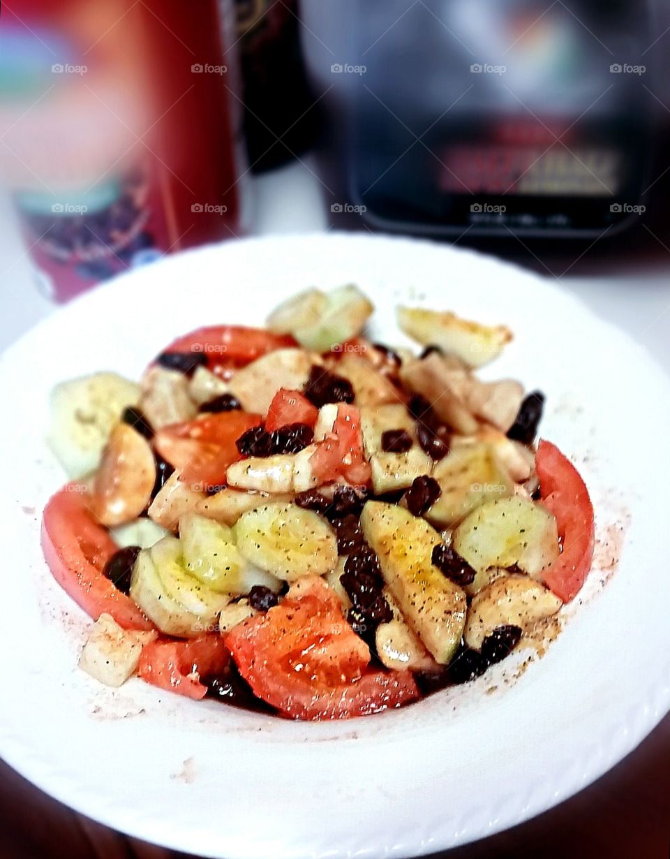 summer salad. tomatoes, bananas, cucumber, apples, raisins, w/ lemon juice & balsamic vinegar & a touch of seasoned salt/pepper