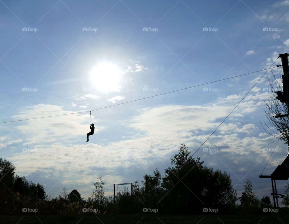 a silhouette of a gliding person