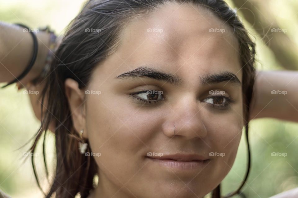 Young women of Turkish origin smooths back her hair after swimming