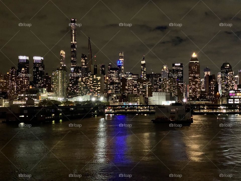 The New York City skyline at night viewed from the Hudson River