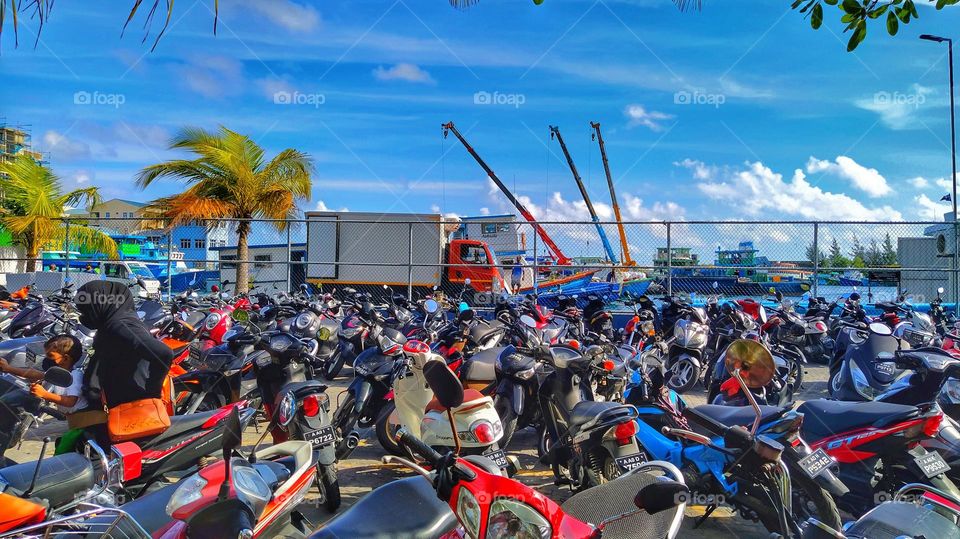 Thousands of colourful scooters in the parking area in Malè, Maldives