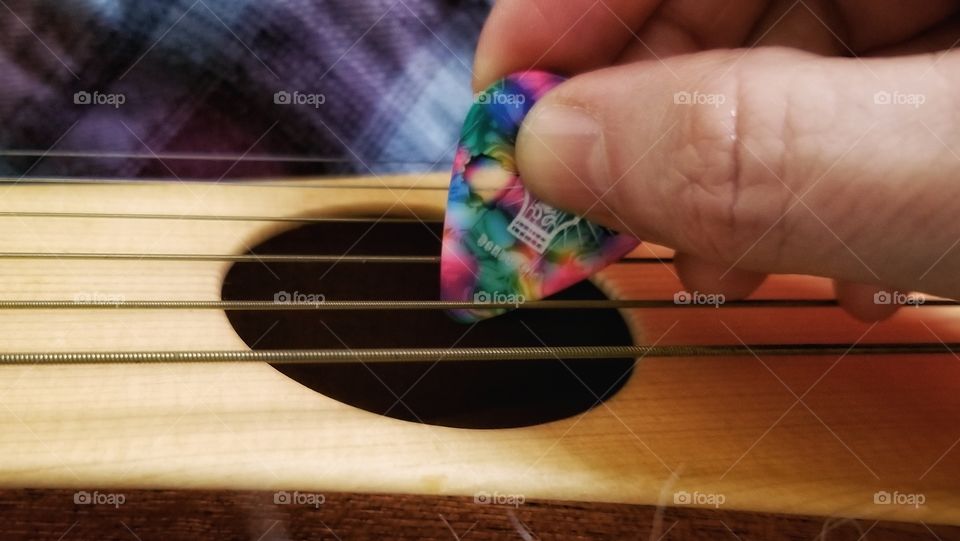 Pick Playing a Guitar