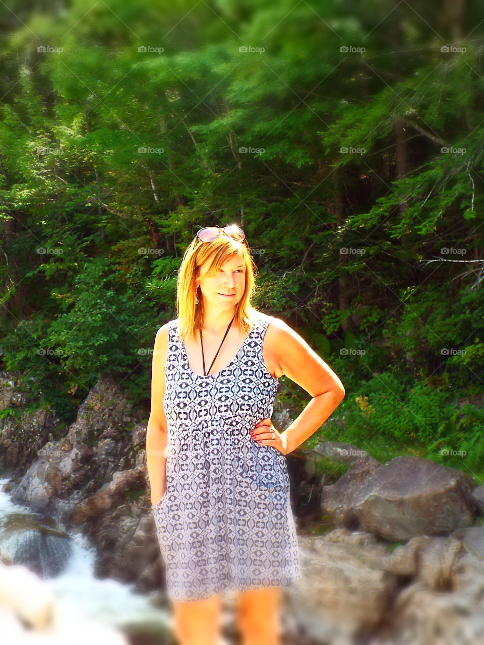 Closeup of attractive blonde adult woman looking to side in summer dress swimsuit cover up in white forest New Hampshire in summer