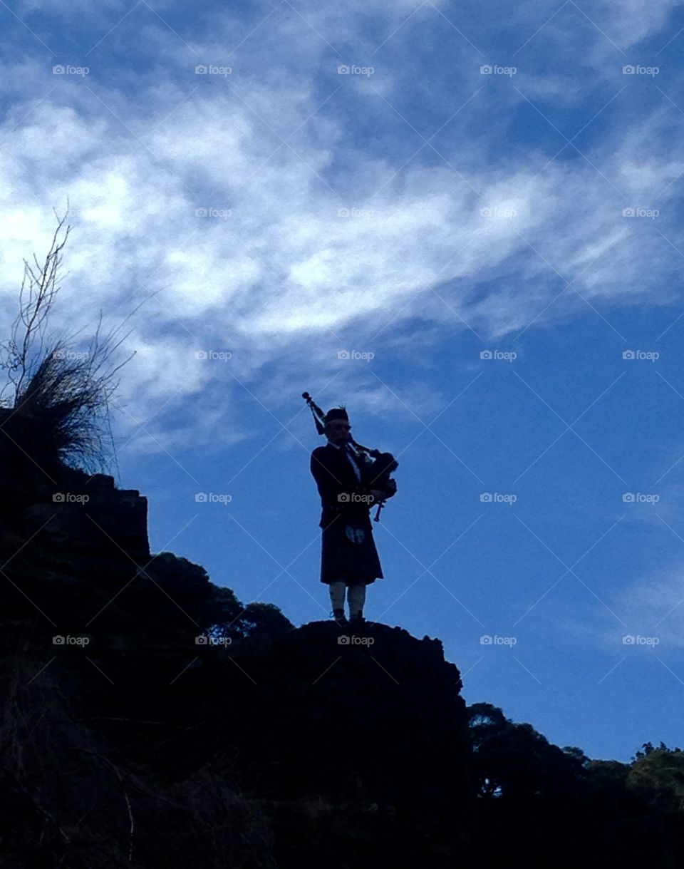 Bagpiper playing in the valley 
