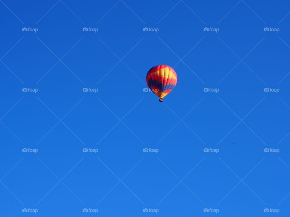 Hot air balloon flying in clear sky