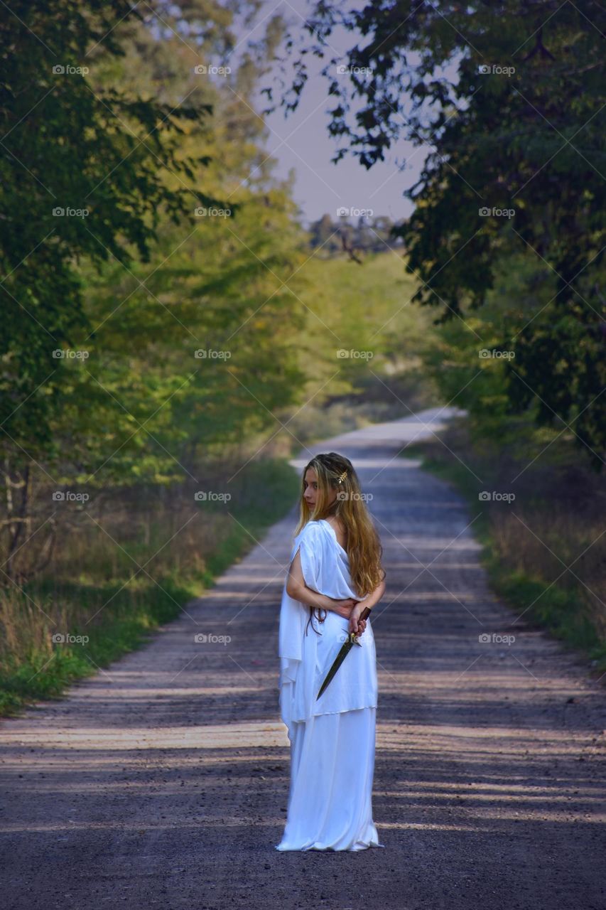 woman with greek goddes inspired costume in a forest