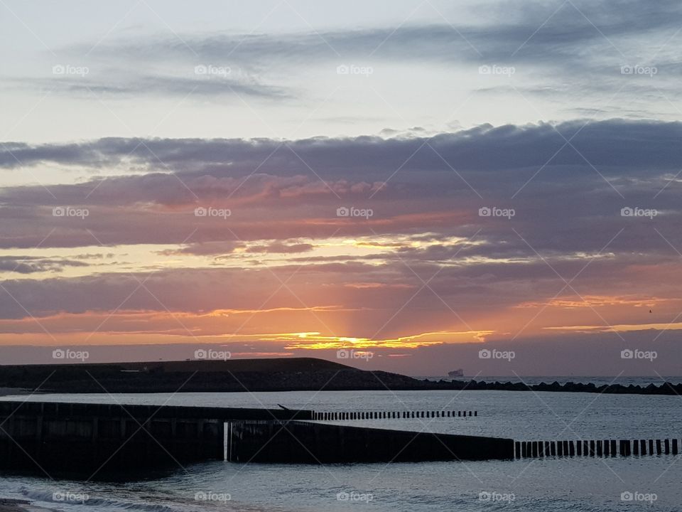 Sunsets on a summer evening. beautiful red, orange colored above the water.