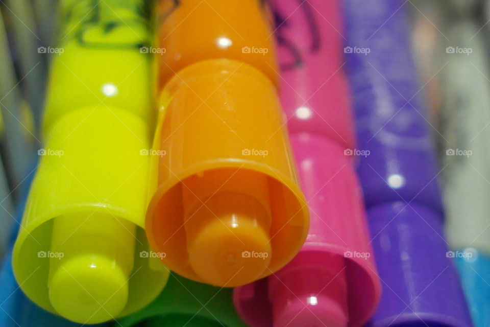 Brightly colored marker tops