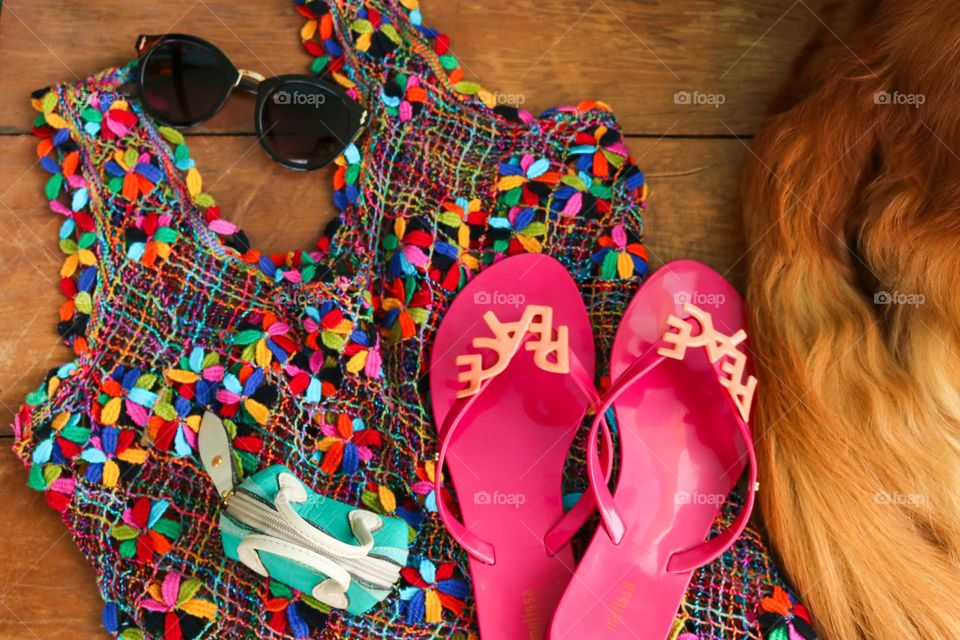 A colorful light dress, flip-flops, sunglasses, a tiny purse for money and the company of my golden retriever is everything I need at the beach.