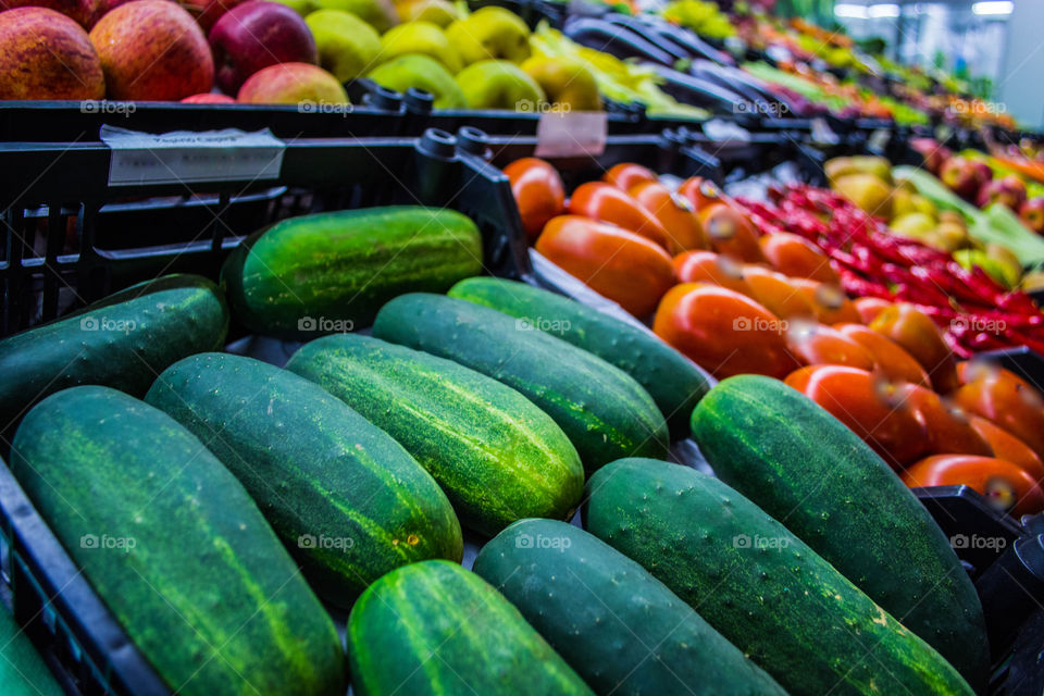 Fresh cucumber and other vegetables at organic fair