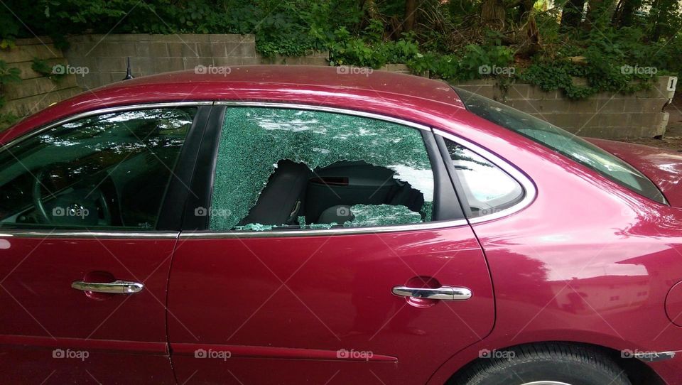 car window. rock thrown through car window