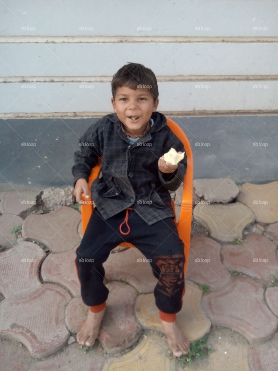 little boy
enjoying
eating
natural laugh
chair