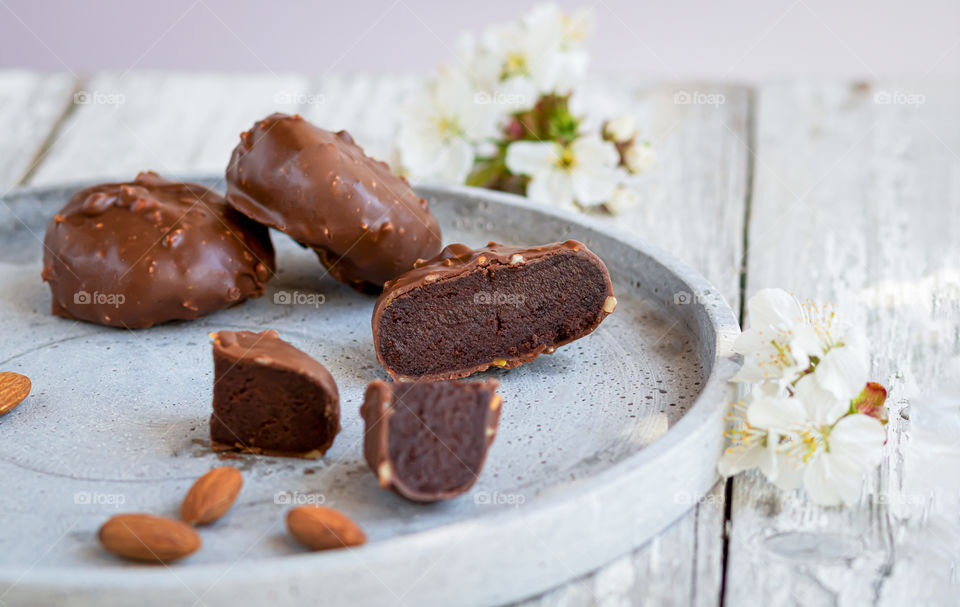 Traditional handmade dessert Cake pops made by chocolate and almond flour on the wooden background.