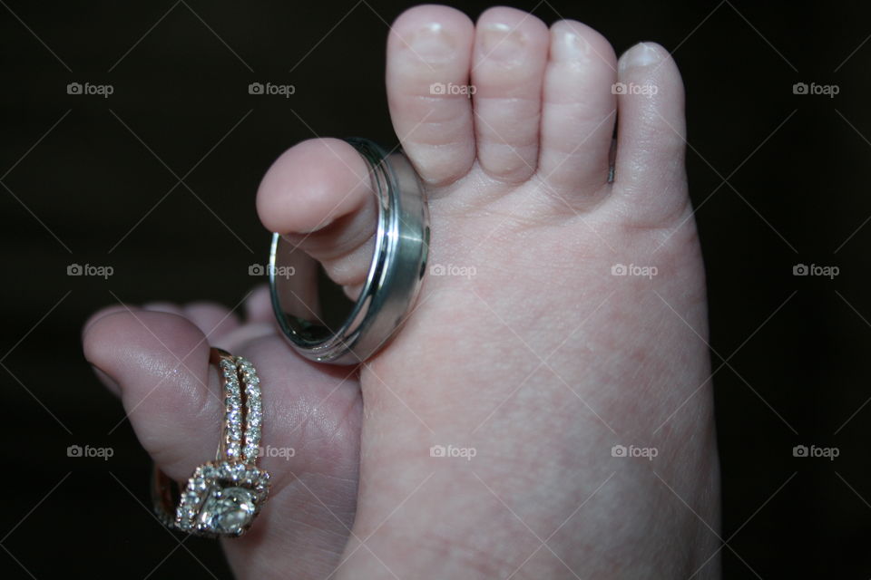 Infant with parents wedding rings on toes