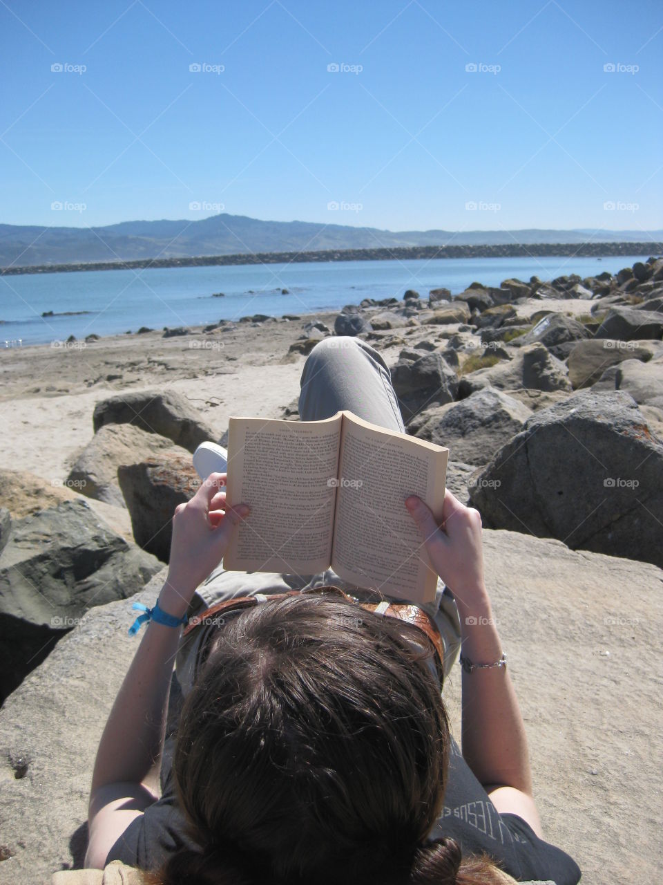 Reading on the Beach. A girl reading on the beach in California.