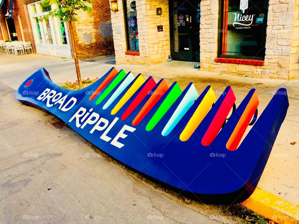 Unique colorful bike rack freshly painted and disguised as a giant comb outside of a local hair salon 