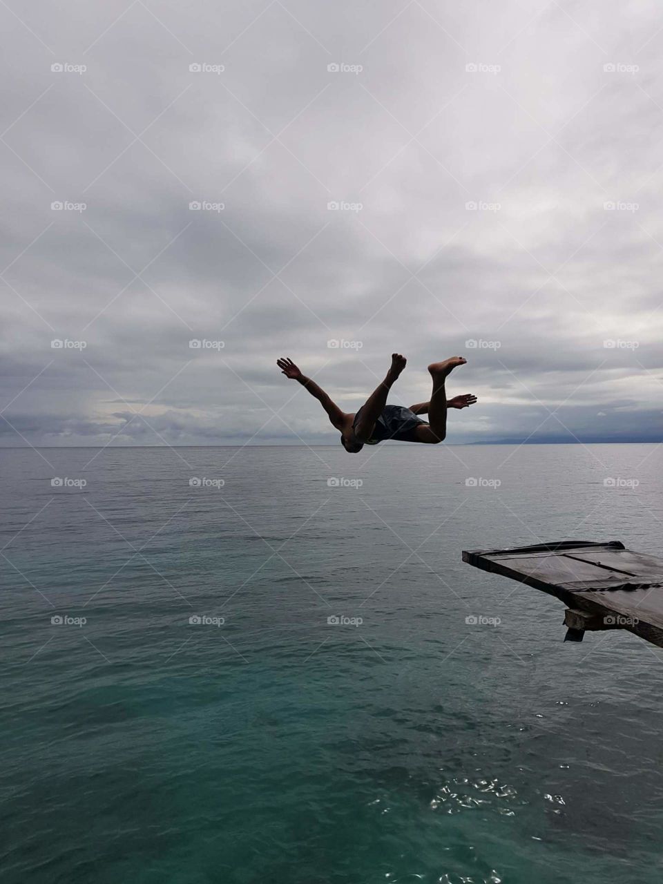 Diving high to the clear water sea..
