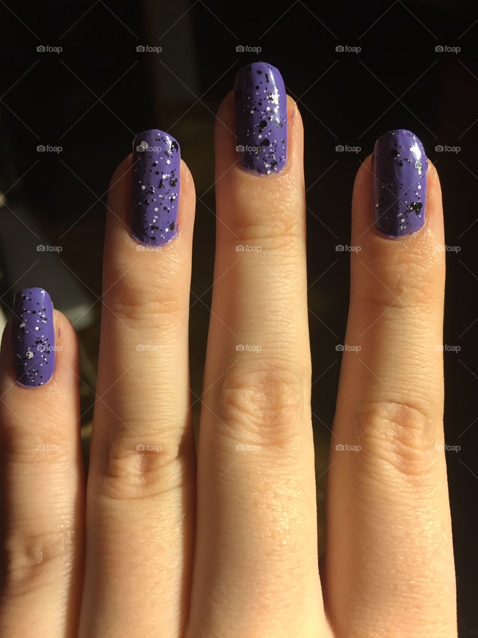 added a black and white speckled top coat to purple nails for something different 