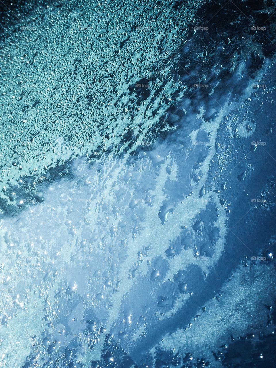 Wet and damp. A wet window of a car