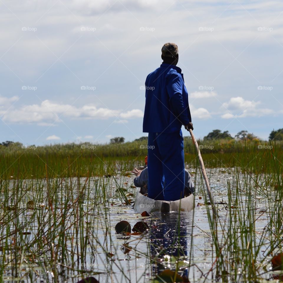Canoe poler on the river in Botswana’s Okavango Delta