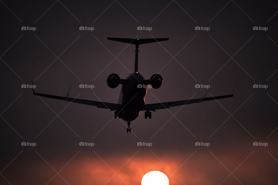 Airplane Flying Into Sunset