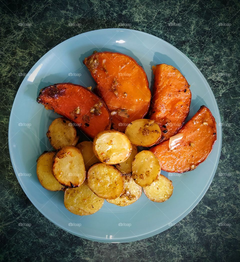 Tasty roasted pumpkin with potatoes and garlic