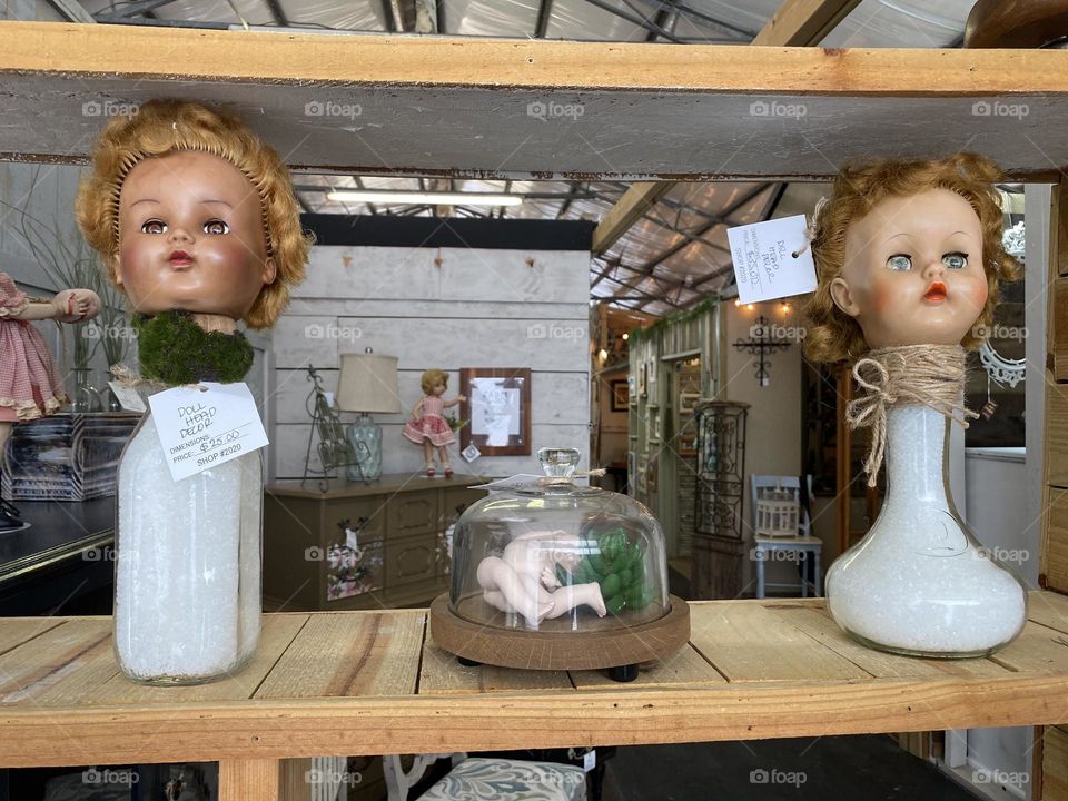 Creepy doll heads on bottles