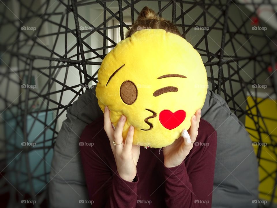 Girl with emoji pillow