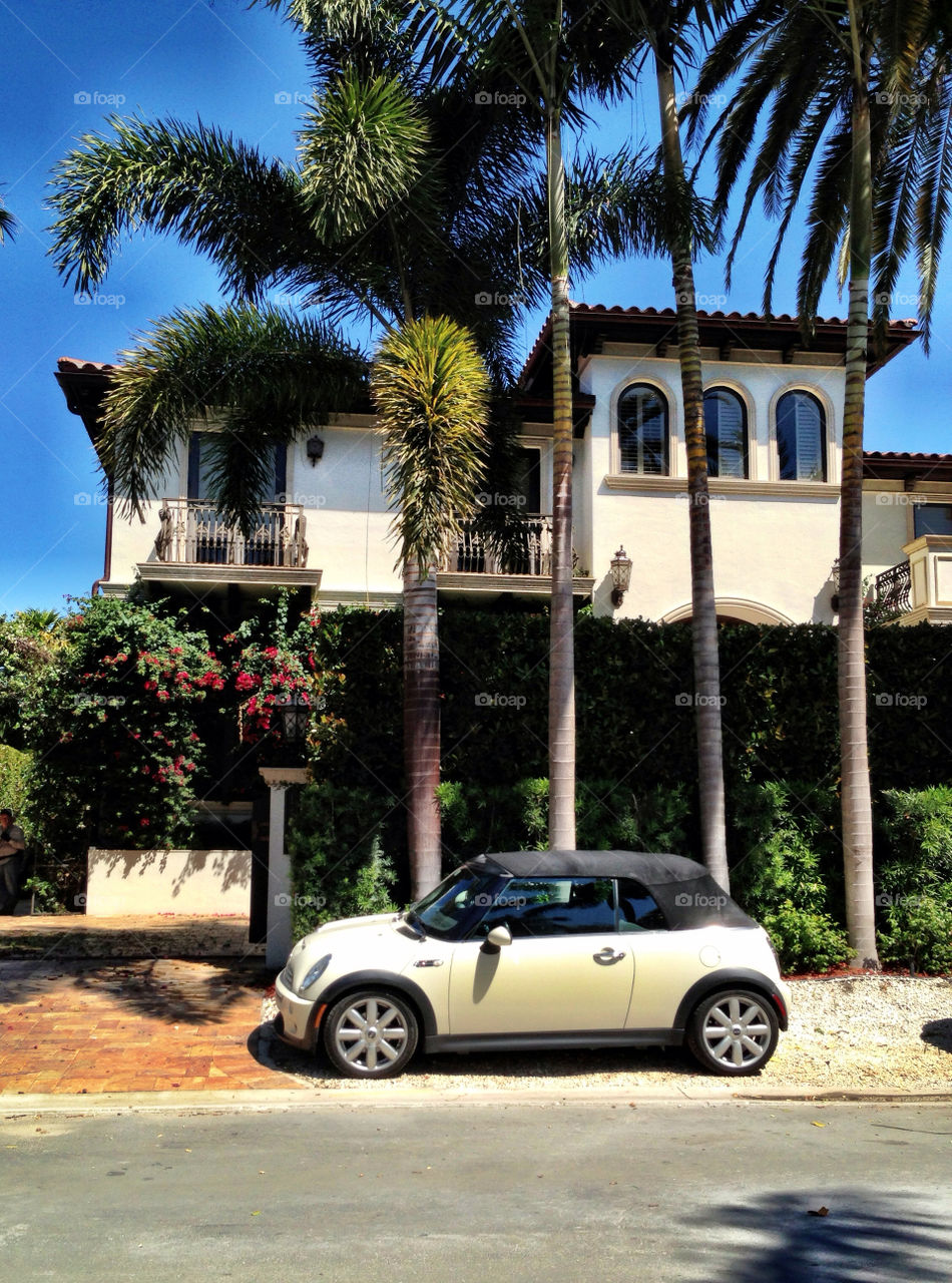 Mini Cooper car parked in front of mansion at Miami Beach, Florida